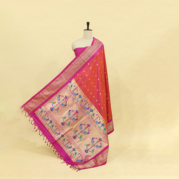 Mannequin showcasing the elegant drape of a pinkish orchid Banarasi silk suit with a vibrant golden Paithani dupatta featuring colorful floral motifs.