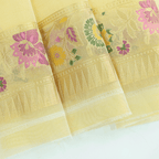 Flat lay view of the premium unstitched organza blouse fabric featuring a coordinating woven border included with the Celestial Charm saree.