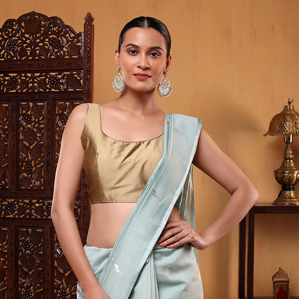 Elegant full drape view of the pastel green festive Banarasi cotton saree showcasing its graceful fall and shimmering zari borders