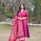 Woman wearing a pink and purple handwoven Banarasi silk suit with gold and silver Sona Rupa motifs, paired with a striped organza tissue dupatta.