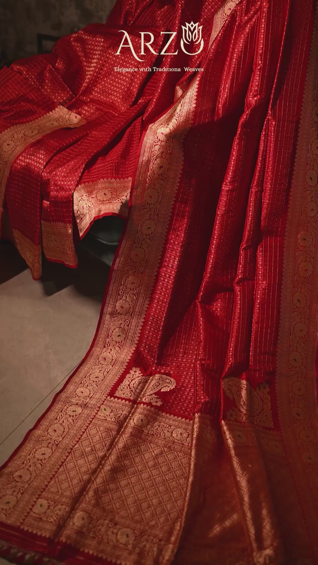Product video of the Red Handwoven Organza Katan Silk Saree, showing the shimmering gold zari border and the soft, crisp drape of the Banarasi silk in motion