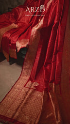Product video of the Red Handwoven Organza Katan Silk Saree, showing the shimmering gold zari border and the soft, crisp drape of the Banarasi silk in motion