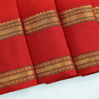 Macro shot of the rich texture and fine weave variations of the premium handwoven yellow and red pure Banarasi silk festive saree.