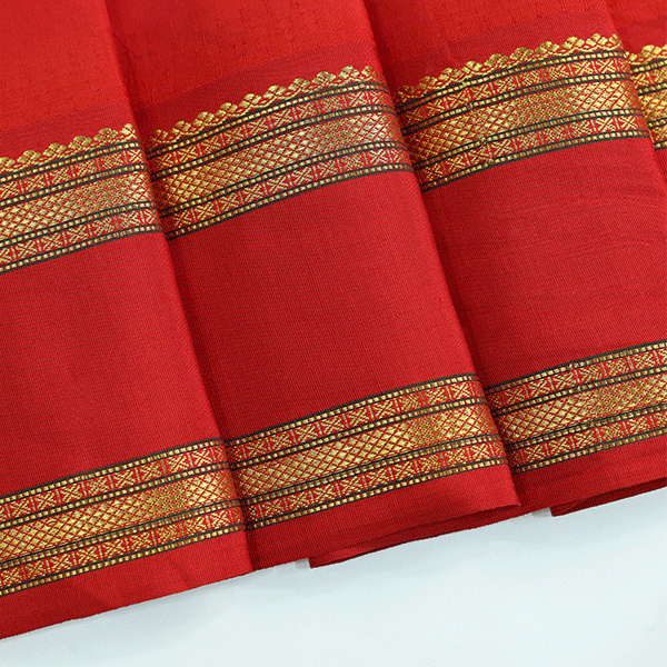 Macro shot of the rich texture and fine weave variations of the premium handwoven yellow and red pure Banarasi silk festive saree.