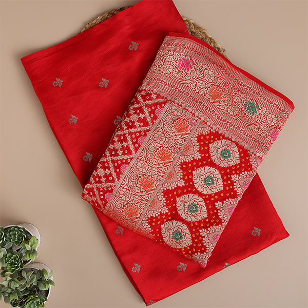 Detailed close-up of the premium Crimson Kaleidoscope pure Banarasi silk suit fabric highlighting the luxury texture and intricate traditional handloom weave.