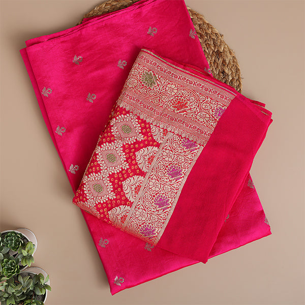 Close-up view of the intricate traditional Banarasi weaving and opulent fabric texture on the vibrant magenta silk suit material.
