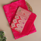 Close-up view of the intricate traditional Banarasi weaving and opulent fabric texture on the vibrant magenta silk suit material.