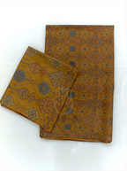 Folded mustard yellow pure Boski silk suit fabric set displaying all-over geometric jaal pattern with slate blue motifs and matching printed dupatta border