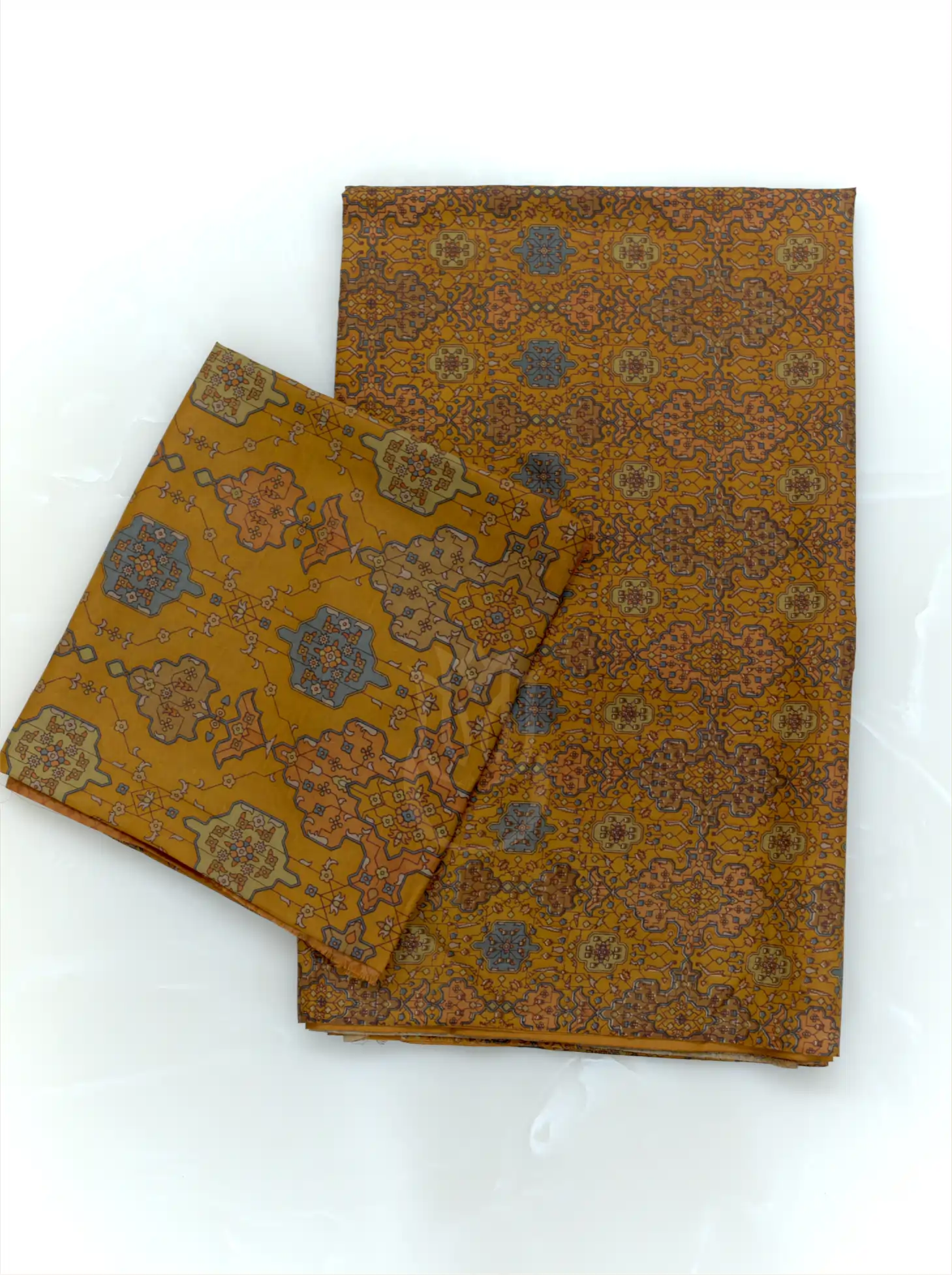 Folded mustard yellow pure Boski silk suit fabric set displaying all-over geometric jaal pattern with slate blue motifs and matching printed dupatta border
