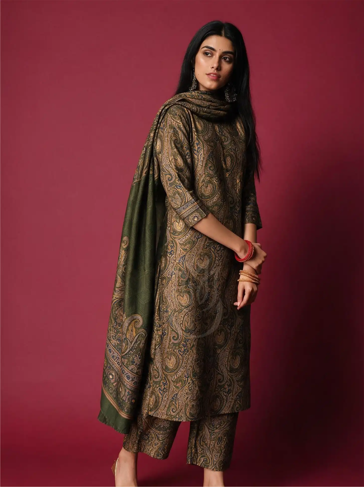Model wearing Pure Boski Silk Olive Green Suit Set with paisley printed kurta, matching trousers, and draped olive green dupatta