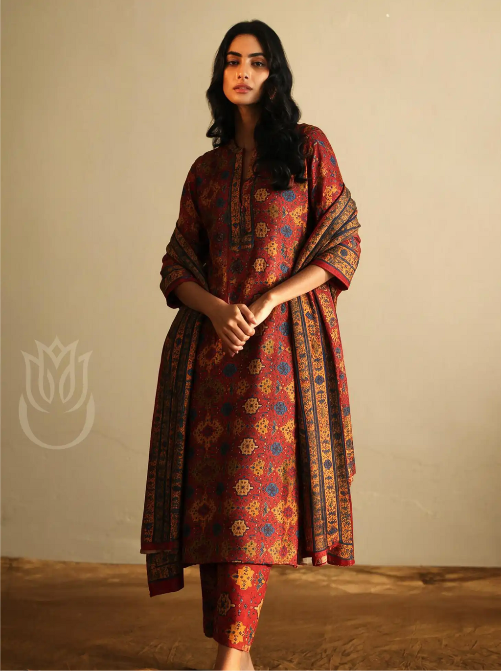 Model wearing Pure Boski Silk Suit Set in Rust Red featuring traditional geometric print with decorated border and matching dupatta