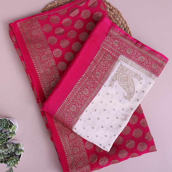 Detailed close-up of the deep maroon pure crepe silk fabric highlighting the luxury texture and intricate traditional golden handloom weaving.