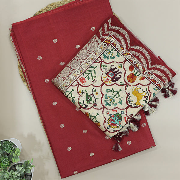 Detailed close-up of the premium Crimson Elegance handwoven pure Banarasi silk suit fabric highlighting the luxury texture and traditional handloom weave.