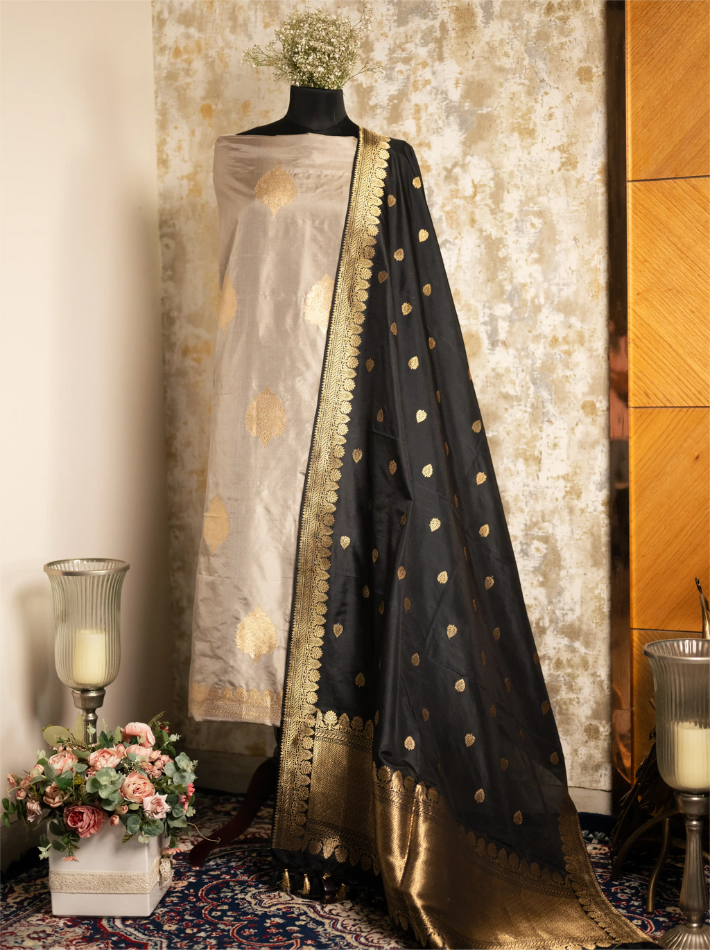 Mannequin wearing a beige Pure Kadwa Katan Silk suit paired with an elegant black and gold zari-bordered dupatta.