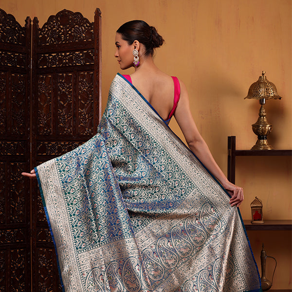 Detailed close-up of the premium Blush Shikargah Elegance pure Katan silk fabric showcasing its luxury texture and intricate traditional handwoven gold motifs.
