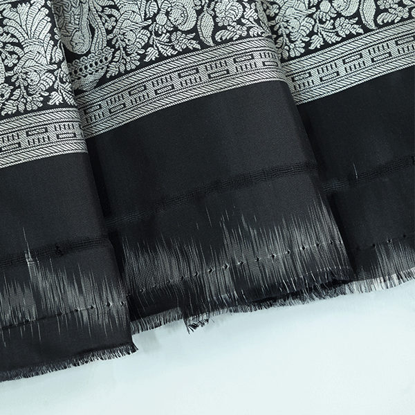 Macro shot of the premium pure katan silk fabric weave, displaying the elegant drape, texture, and sophisticated sheen of the festive saree.