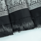 Macro shot of the premium pure katan silk fabric weave, displaying the elegant drape, texture, and sophisticated sheen of the festive saree.