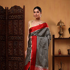 Close-up detail of the premium handloom Crimson Majesty pure satin silk fabric showcasing its smooth luxury texture and sheen.