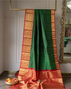 Detail view showing the luxurious natural sheen and texture of the pure silk emerald green fabric