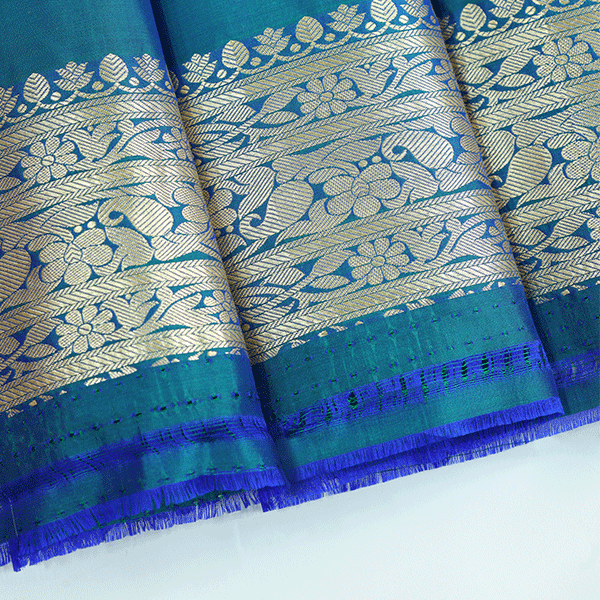 Flat lay view of the unstitched premium pure silk blouse fabric featuring a matching handwoven gold border included with the saree.