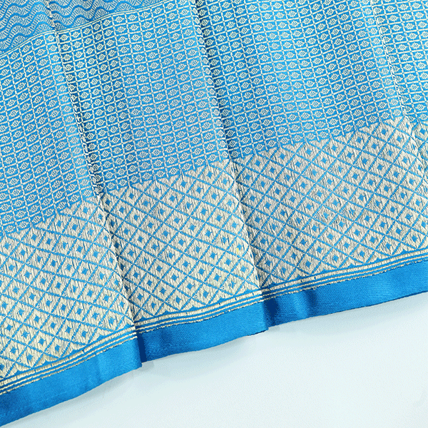 Macro shot of the authentic Banaras handloom pure tissue silk Jamdani fabric highlighting its fine sheen and metallic weave texture.