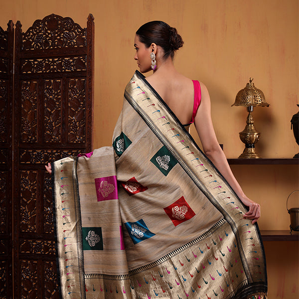 Close-up shot of the handwoven pure Tussar silk fabric, showcasing the fine details of the multicoloured zari bootas and luxurious handloom texture.