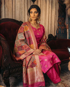 A woman wearing a premium Rani Pink pure Banarasi silk suit set paired with a vibrant multicolour Banarasi dupatta.