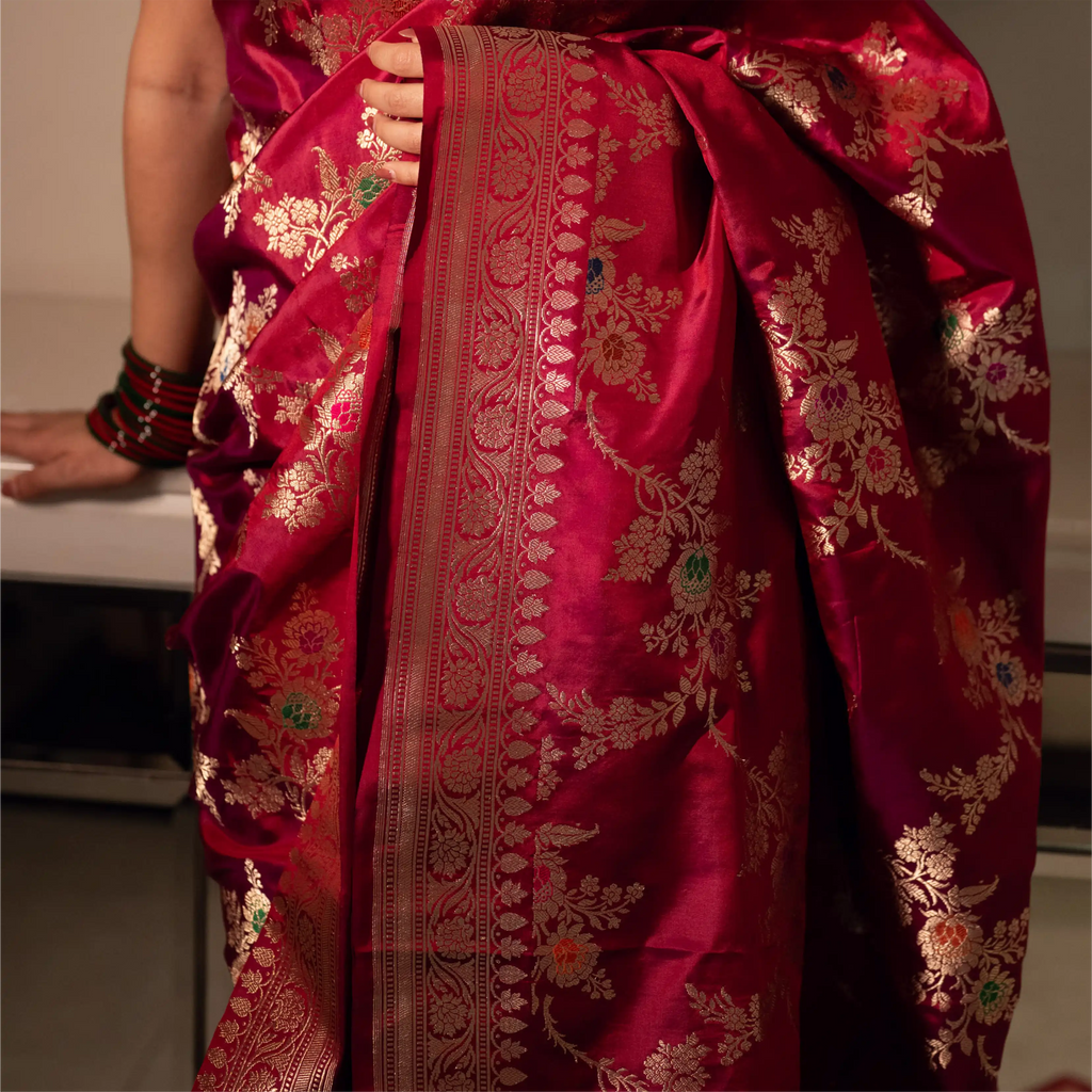 Mid-shot of a Red Handwoven Katan Silk Saree highlighting the rich gold zari work on the pallu and the intricate floral vine border.