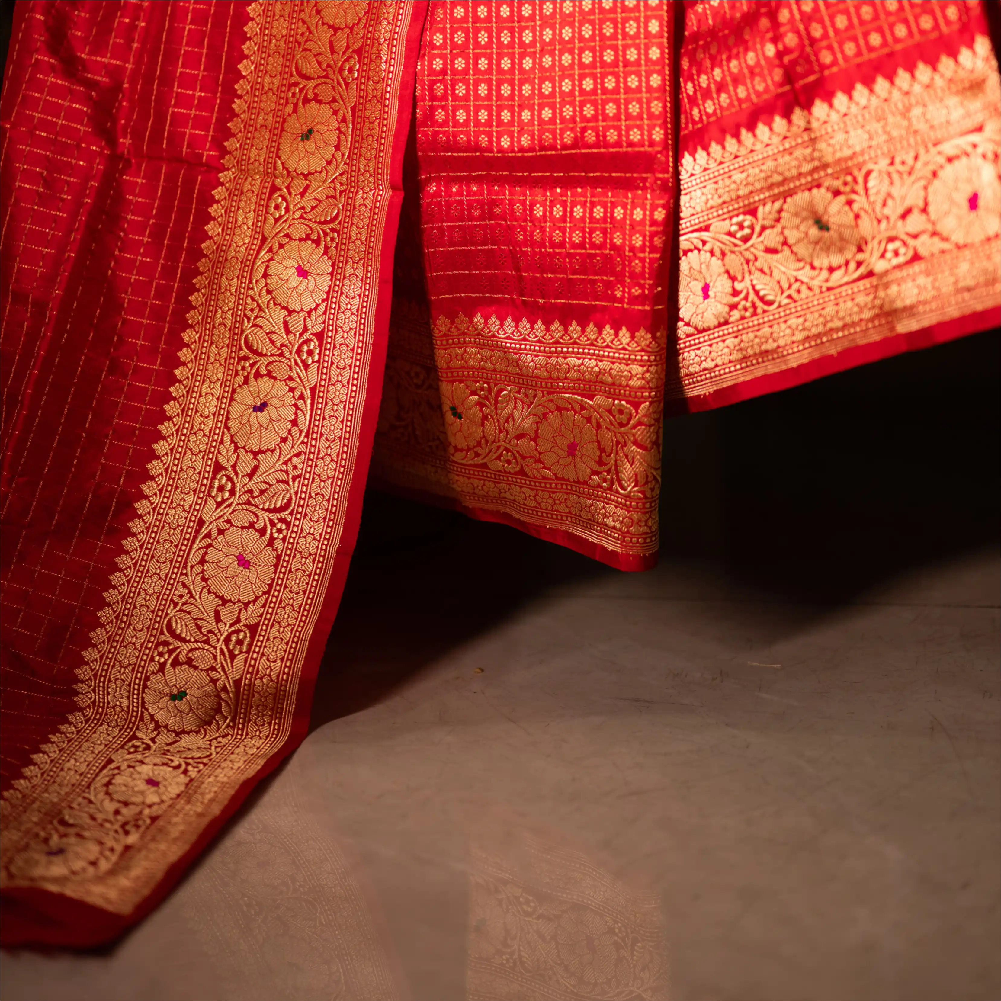 Side view of the Red Handwoven Organza Katan Silk Saree showing the elegant fall of the fabric and the decorative gold zari pallu.