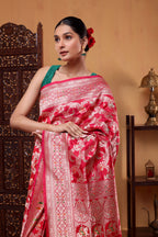 A elegant model draped in the Regal Crimson Shikargah Katan Silk Saree, showcasing the rich crimson red body, Meenakari four-sided border, and intricate handwoven patterns.