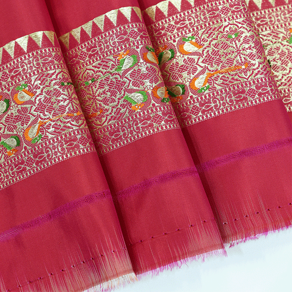 Close-up view of the 1-meter unstitched crimson silk blouse fabric piece featuring a matching traditional Meenakari border.
