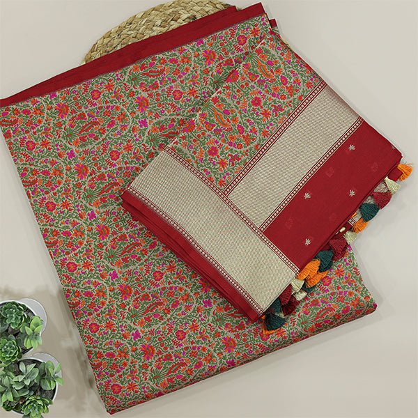 A beautiful flat-lay of a rich red handwoven Banarasi silk suit set, featuring intricate floral patterns, premium zari border detailing, and a coordinating contrast dupatta with traditional tassels.