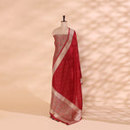 A mannequin displaying a luxurious deep red handwoven Banarasi silk suit set, featuring intricate gold zari floral motifs, fine craftsmanship, and an elegant traditional drape.