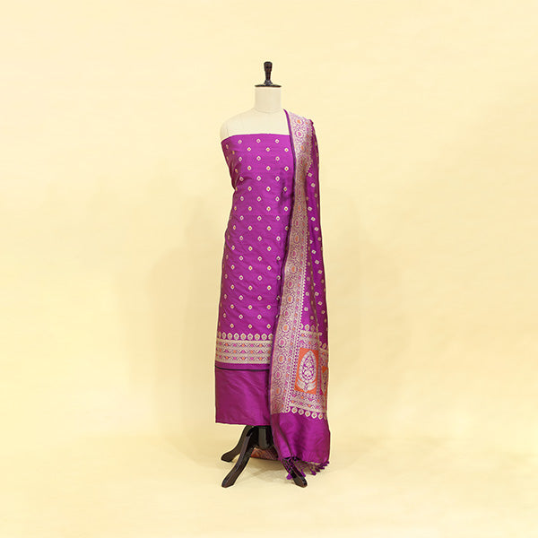 A rich, velvety wine-colored pure handwoven Banarasi silk suit with an intricate full Jaal design and elegant neck pattern, displayed on a mannequin.