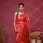 A model elegant draped in the Rose Radiance Kanjivaram silk saree, featuring a vibrant pink magenta body and a heavy golden zari pallu.