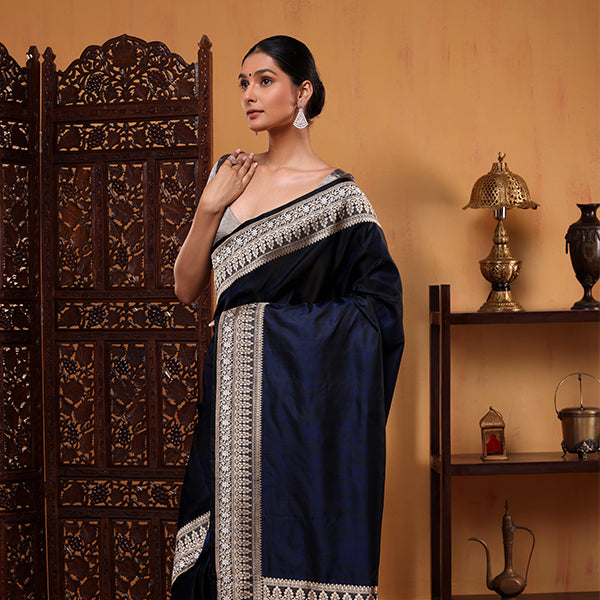 Close-up of a royal blue handwoven Mashru silk saree with intricate silver border detailing.