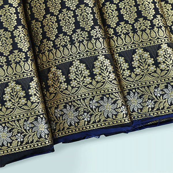 Close-up view of the Royal Blue Mashru Silk Saree showcasing the intricate abstract Jamdaani weave and the unstitched full jaal blouse fabric with a Meenakari border.