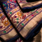 Detailed view of a royal blue Paithani Patola silk saree showing the rich texture of the hand-loomed fabric and intricate gold zari border patterns