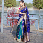 A model wearing a premium royal blue and teal silk saree with intricate gold woven patterns and tassel detailing on the pallu.