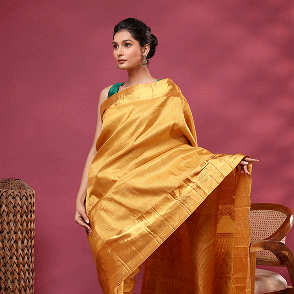 A magnificent display of the rich, heavy handwoven gold Zari pallu on the Royal Mustard Kanjivaram pure silk saree.