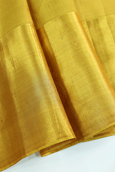 The matching unstitched royal mustard Kanjivaram silk blouse piece featuring an elegant handwoven self-jaal pattern and a classic gold border.