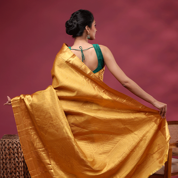 Detailed close-up shot of the Royal Mustard Kanjivaram silk fabric, highlighting the intricate texture of the traditional handwoven gold Suchi Zari work.