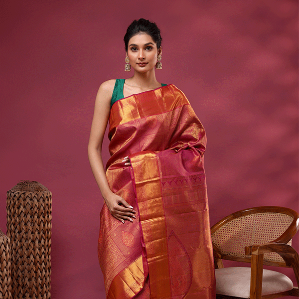 Detailed close-up shot of the rich royal plum Kanjivaram silk fabric, highlighting the fine craftsmanship of the traditional gold Resham weave.