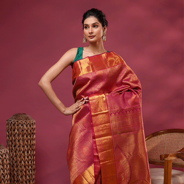 Full-length view of the majestic royal plum Kanjivaram silk saree showcasing the heavy gold zari pallu and its luxurious traditional drape