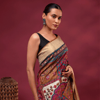 A model showcasing a royal plum unstitched pure Tussar silk saree with intricate hand-embroidered multi-colour Kantha floral patterns and a classic gold zari border.