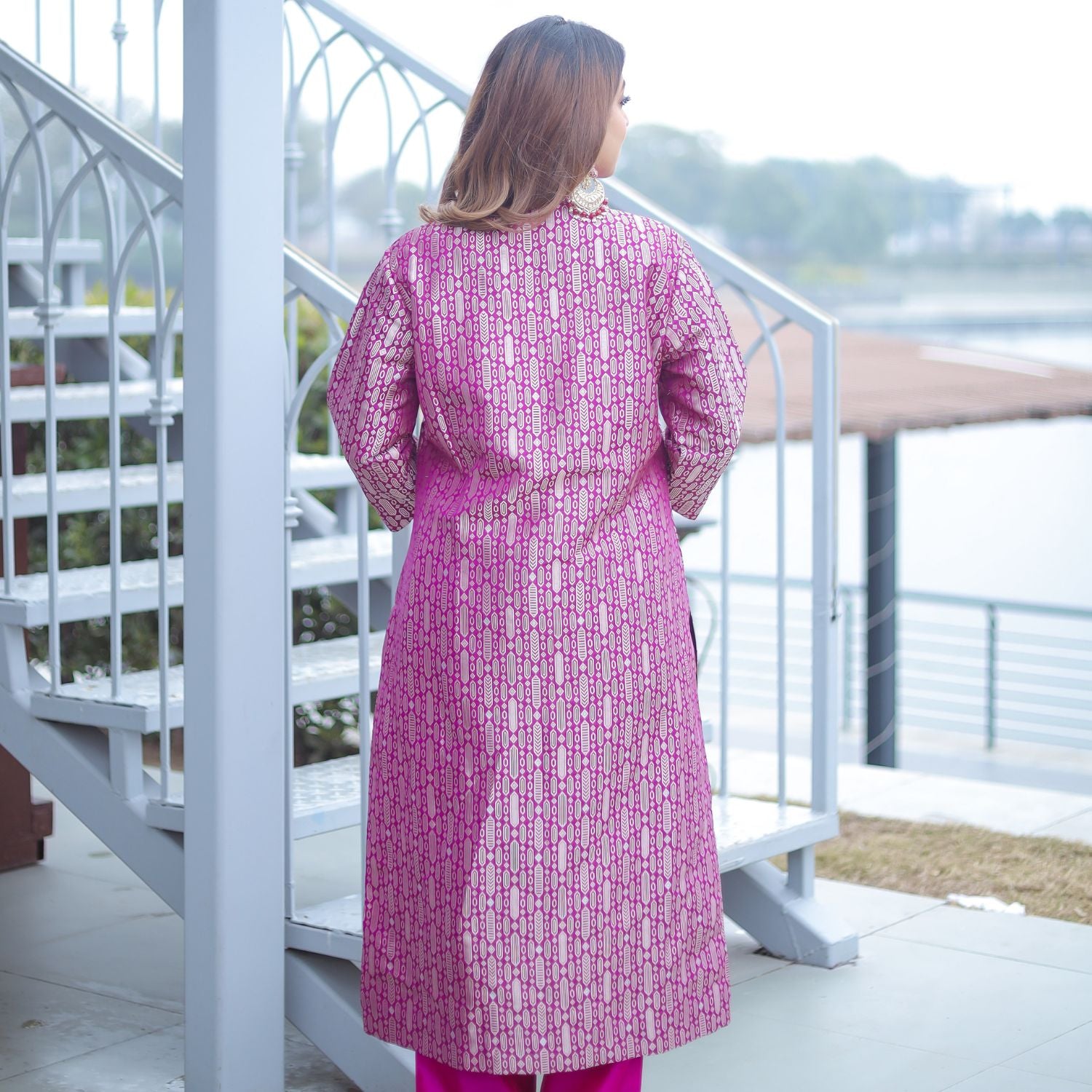 Front view of the Royal Purple Handwoven Brocade Achkan suit, showing the deep green silk contrast lining through the side slits and the vibrant matching purple pants.