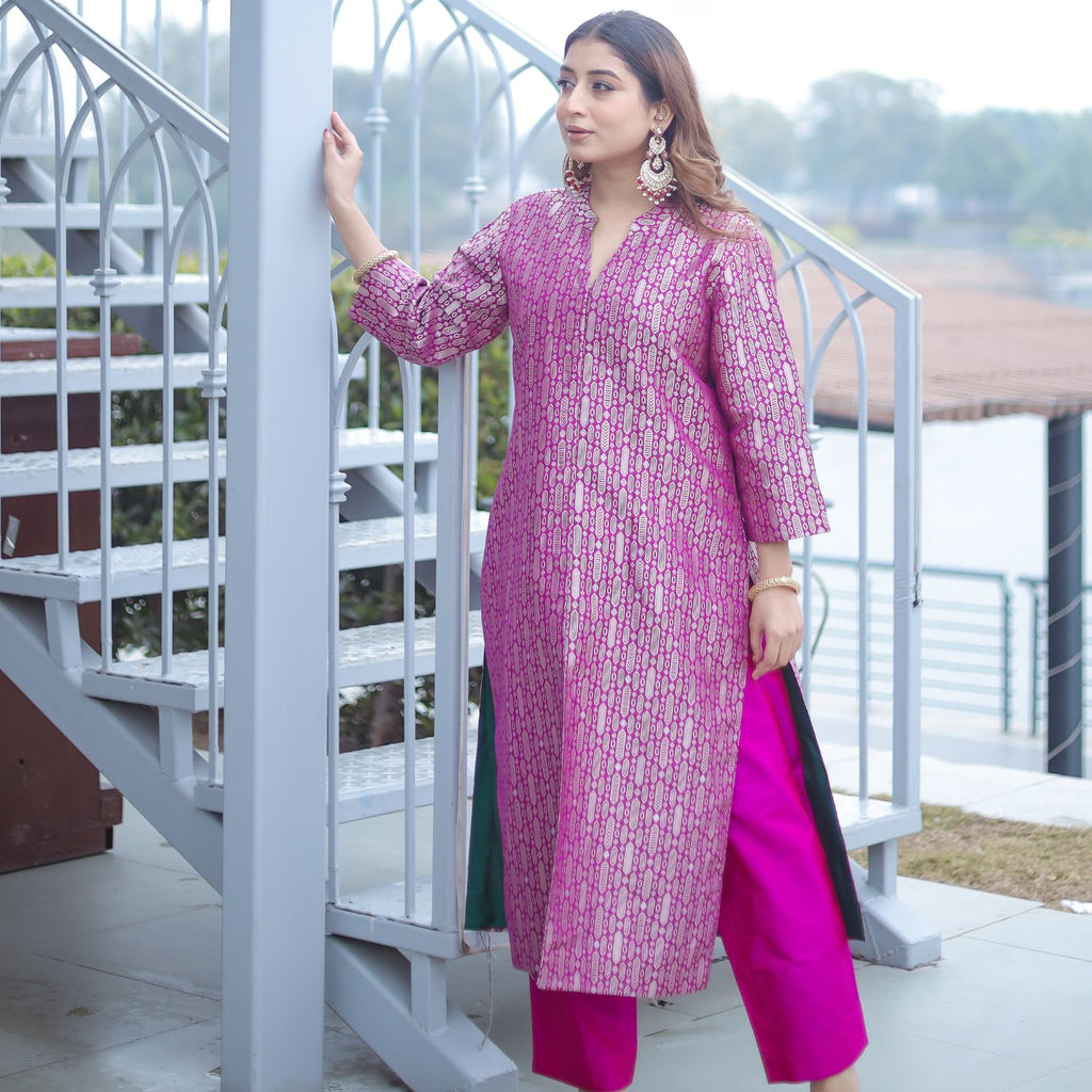 Front view of the Royal Purple Handwoven Brocade Achkan suit, showing the deep green silk contrast lining through the side slits and the vibrant matching purple pants.