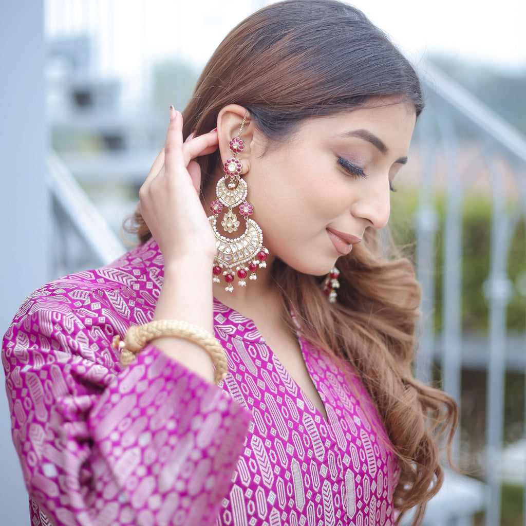 Close-up portrait of a woman wearing a Royal Purple Handwoven Brocade Achkan, highlighting the high neckline, gold zari floral patterns, and traditional jewelry.