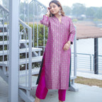 Model wearing the Royal Purple Handwoven Brocade Achkan suit, showcasing the long tunic silhouette, matching silk pants, and side slits with deep green lining