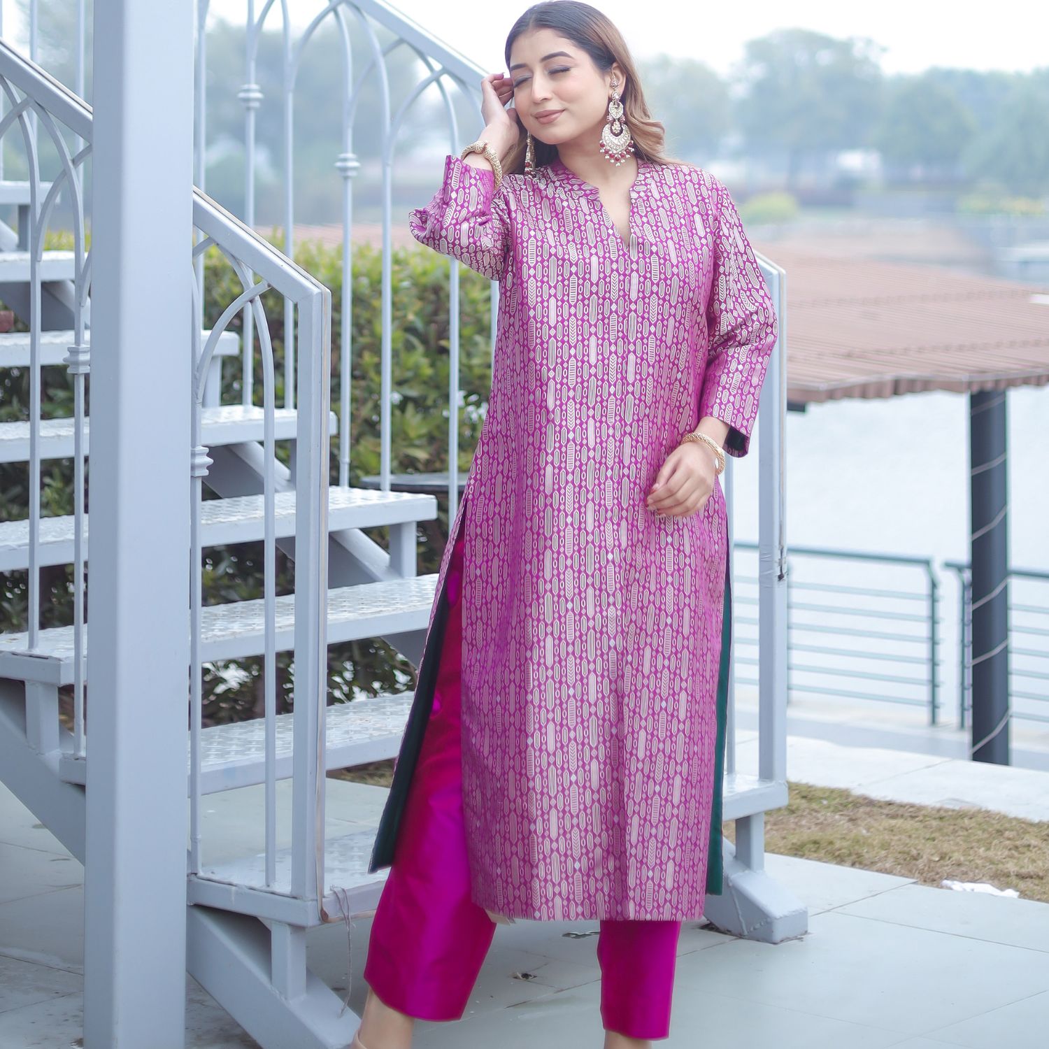 Model wearing the Royal Purple Handwoven Brocade Achkan suit, showcasing the long tunic silhouette, matching silk pants, and side slits with deep green lining
